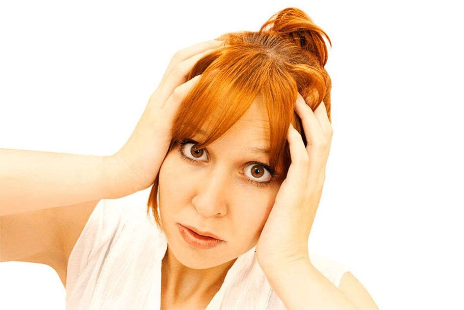 A woman holds her head